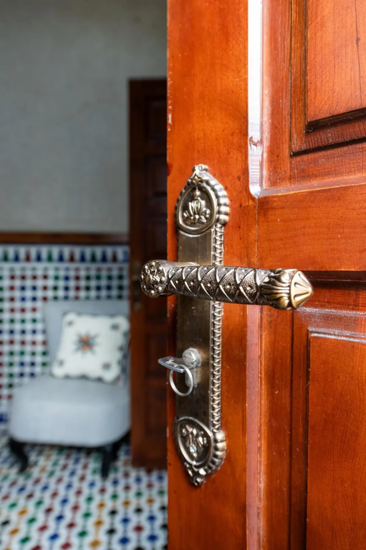 Brass handle on a carved wooden door