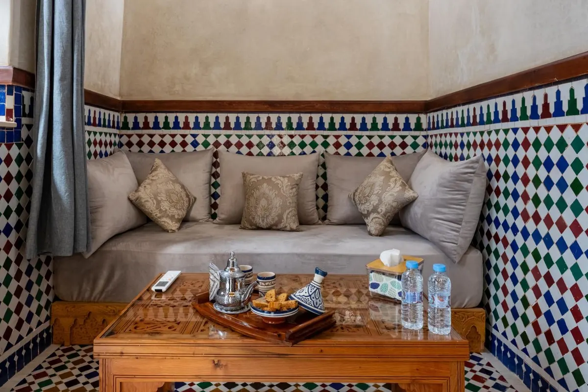 Lower level: banquette sofa, tea tray and tiled floor